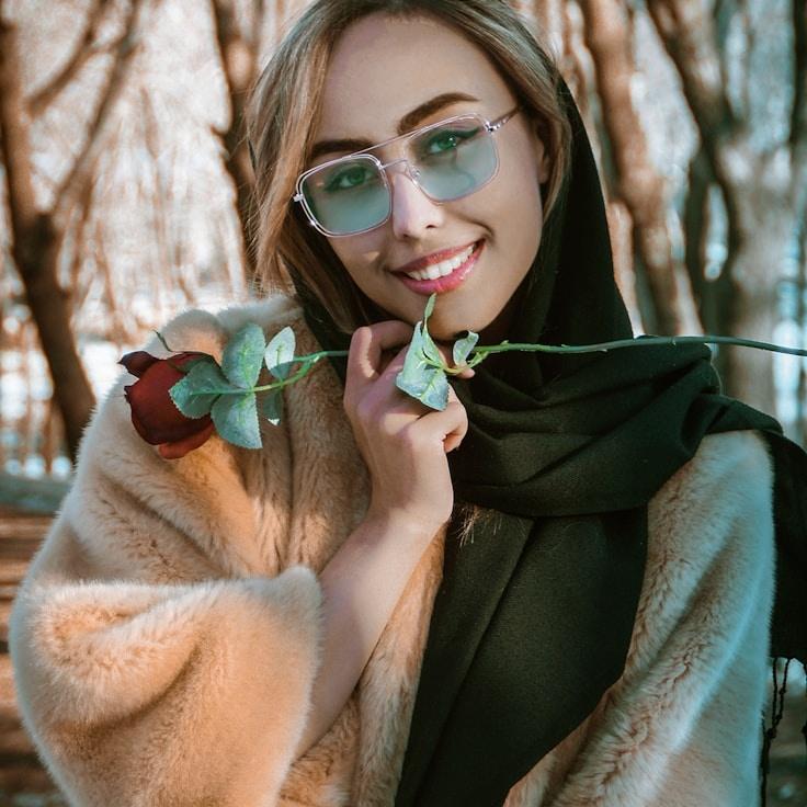 Avery Chen, Lead Design Curator at GroveCanvasRidge, reviewing corporate floral arrangements